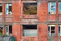 A fragment of an old abandoned red brick building with broken windows Royalty Free Stock Photo