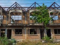 Abandoned building by front perspective of unfinished house with degenerate structure