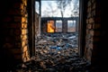 Abandoned building interior with debris and fire in background showcasing desolate atmosphere remnants of walls and scattered Royalty Free Stock Photo