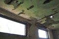 Abandoned building interior. A shabby desolate room with empty broken windows, mold, dust and cobwebs on the walls. The