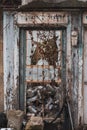 Abandoned building with old retro doors. Clouse-up of a very old weathered wooden door. Royalty Free Stock Photo