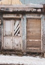 Abandoned building with old retro doors. Clouse-up of a very old weathered wooden door. Royalty Free Stock Photo