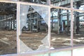 Broken and cracked industrial windows in metal frames Royalty Free Stock Photo