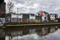 The abandoned buildings painted by graffiti , along the Regent Canal, near Broadway road. Urban area.