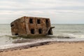 Abandoned buildings on the seashore in the water. War ruins decomposing in the Baltic sea. Former fort bunkers in Liepaja, Latvia