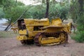 Abandoned bulldozer. yellow mechanical old man. Nature is stronger than technology