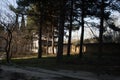 Abandoned burned old house in winter at sunset in forest. Abandoned hunting lodge in the warm rays of the sun in the middle of the Royalty Free Stock Photo