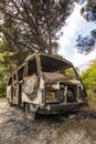 Abandoned burning van next to a forest Royalty Free Stock Photo