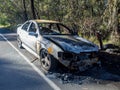 Abandoned burnt out car at the road side front image Royalty Free Stock Photo