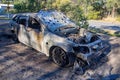 Abandoned burnt out car station wagon front right hand side Royalty Free Stock Photo