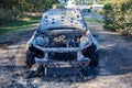 Abandoned burnt out car station wagon front side Royalty Free Stock Photo