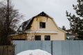 An abandoned burnt-out house on one of the streets of a provincial town on a cloudy winter day Royalty Free Stock Photo