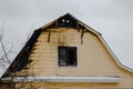 An abandoned burnt-out house on one of the streets of a provincial town on a cloudy winter day Royalty Free Stock Photo