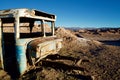 Old bus forgotten in the middle of the desert rusting by itself