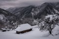 Abandoned cabin after snowstorm in winter mountains Royalty Free Stock Photo