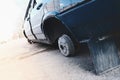 Abandoned car with broken wheels on the street Royalty Free Stock Photo