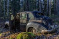 Abandoned car from the forties left to rust in a forest in Sweden Royalty Free Stock Photo