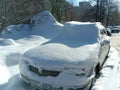 The abandoned car was covered in snow after a heavy snowstorm in the city Royalty Free Stock Photo