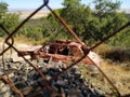 Abandoned car in the woods behind a fence Royalty Free Stock Photo