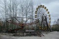 Abandoned carousel and abandoned ferris at an amusement park in the center of the city of Pripyat, the Chernobyl disaster,