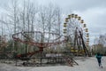 Abandoned carousel and abandoned ferris at an amusement park in the center of the city of Pripyat, the Chernobyl disaster,