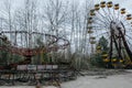 Abandoned carousel and abandoned ferris at an amusement park in the center of the city of Pripyat, the Chernobyl disaster, the