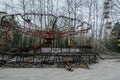 Abandoned carousel and abandoned ferris at an amusement park in the center of the city of Pripyat, the Chernobyl disaster,