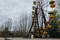 Abandoned carousel and abandoned ferris at an amusement park in the center of the city of Pripyat, the Chernobyl disaster, the exc