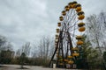 Abandoned carousel and abandoned ferris at an amusement park in the center of the city of Pripyat, the Chernobyl disaster,