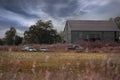 Abandoned cars and a truck in Farmers Field near Barn