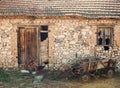 Abandoned cart next to ruins. Old cart near stone wall. District with old buildings, old building made of stones