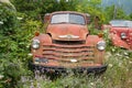 An abandoned 1948 Chevy 6400 truck surrounded by weeds in a junkyard in Idaho, USA - July 26, 2021