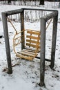 Abandoned children swings in a public park at wintertime Royalty Free Stock Photo