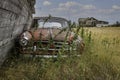 An abandoned classic car and farmhouse on the Saskatchewan prairies