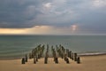 Stormy clouds over the sea. Old wooden pier on the shore. Royalty Free Stock Photo