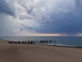 Stormy clouds over the sea. Old wooden pier on the shore. Royalty Free Stock Photo