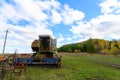 Abandoned combine harvester. Rusty spoiled combine harvester.