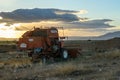 Abandoned Combine Harvester at Sunset in Rural Field Royalty Free Stock Photo