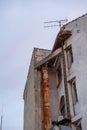 Abandoned Concrete Building with Rusty Metal Chimney and Old Antenna