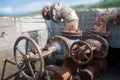 Abandoned concrete well with old water-gate valves.