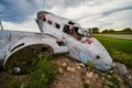 Abandoned crashed small airplane in fields on cloudy day