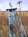 Abandoned ramshackle monument to the unknown memory with a cross in the box