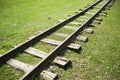 Abandoned cuckoo railway surrounded by green grass. Royalty Free Stock Photo