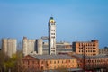 Abandoned damaged old granary against town and blue cloudy sky