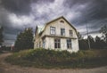 Abandoned, decaying old house by a road and dramatic sky Royalty Free Stock Photo