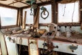 Abandoned and demolished cargo ship bridge inside view with throttle levers, communication devices and equipment