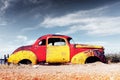 Abandoned derelict old car in the sandy desert Royalty Free Stock Photo