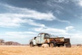 Abandoned derelict old car in the sandy desert Royalty Free Stock Photo