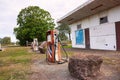 Abandoned derelict service station with petrol pumps