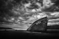 Abandoned desolate rusty ship in black and white color